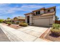 Beige home featuring a tile roof, landscaped front yard, and a two-car garage at 4633 E Desert Cactus St, Phoenix, AZ 85032