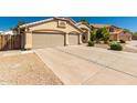 Inviting single Gathering home with a three car garage and desert landscaping at 632 W Natal Cir, Mesa, AZ 85210