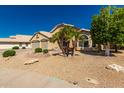 Inviting single Gathering home with desert landscaping and mature palm trees at 632 W Natal Cir, Mesa, AZ 85210