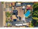 Aerial view of a home with a large backyard featuring a pool, covered patio, and ample space for outdoor activities at 7240 W Grovers Ave, Glendale, AZ 85308