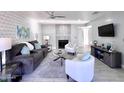 Bright living room featuring modern furniture, a decorative fireplace, and stylish wall accents at 850 S River Dr # 1085, Tempe, AZ 85281