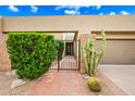 Brick walkway leading to a private courtyard and entrance, desert landscaping and mature trees at 9120 N 86Th Way, Scottsdale, AZ 85258