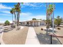 Attractive home boasting neat desert landscaping, a sidewalk, and a welcoming front porch at 9349 E Navajo Pl, Sun Lakes, AZ 85248