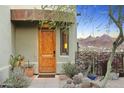 Stunning desert landscape framing a gorgeous wood front door with mountain views at 10005 N 1St Dr, Phoenix, AZ 85021
