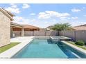 Backyard with a sparkling pool and spa, offering a refreshing escape and beautiful views at 10417 W Alyssa Ln, Peoria, AZ 85383