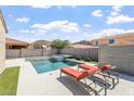 Enjoy resort-style living with a private pool, spa, and lounge chairs in this backyard oasis at 10417 W Alyssa Ln, Peoria, AZ 85383