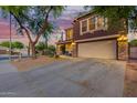 Charming two-story home featuring low-maintenance desert landscaping, a two-car garage, and an inviting front porch at 10561 E Plata Ave, Mesa, AZ 85212