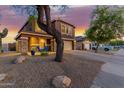 Charming two-story home featuring low-maintenance desert landscaping, a two-car garage, and an inviting front porch at 10561 E Plata Ave, Mesa, AZ 85212