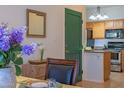 Comfortable dining area showing kitchen, table setting, dark green accent door, and light-filled space at 11333 N 92Nd St # 1085, Scottsdale, AZ 85260