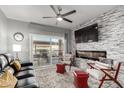 Comfortable living room with a fireplace and access to the covered outdoor seating area at 13700 N Fountain Hills Blvd # 135, Fountain Hills, AZ 85268