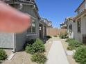 View of the yard showing a walkway between houses with desert landscaping at 14224 W Hackamore Dr, Surprise, AZ 85387