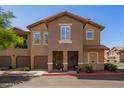 Inviting two-story townhome boasts a well-manicured lawn and covered entry with seating at 14250 W Wigwam Blvd # 2126, Litchfield Park, AZ 85340