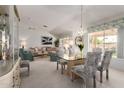 Bright living area featuring neutral tones, a decorative glass table, and vaulted ceilings at 15395 W Pinchot Ct, Goodyear, AZ 85395
