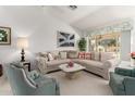 Cozy living room with plush seating, a patterned sofa, and a view of the backyard at 15395 W Pinchot Ct, Goodyear, AZ 85395