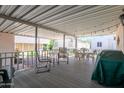 Relaxing back porch with multiple chairs, tables, and string lights at 17200 W Bell Rd # 840, Surprise, AZ 85374