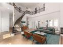 Elegant living room features a grand staircase, high ceilings, and stylish furniture at 2110 E Kerry Ln, Phoenix, AZ 85024