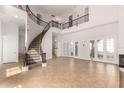 Spacious living room featuring a grand staircase, soaring ceilings, and ample natural light at 2110 E Kerry Ln, Phoenix, AZ 85024