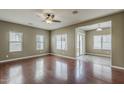 Spacious living room featuring gleaming hardwood floors, a ceiling fan, and lots of natural light at 2144 W Barwick Dr, Phoenix, AZ 85085