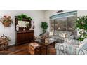 Inviting living room with a large window, stylish furnishings, and hardwood floors at 22026 N 44Th Pl, Phoenix, AZ 85050