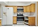 Efficient kitchen design with stainless steel appliances, wooden cabinets, and white countertops at 2306 W Laurel Ln, Phoenix, AZ 85029
