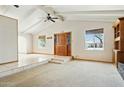 Bright living room featuring vaulted ceilings, tile entry, and neutral carpet flooring for a welcoming space at 2306 W Laurel Ln, Phoenix, AZ 85029