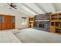 Spacious living room with a brick fireplace, vaulted ceilings, and carpet flooring at 2306 W Laurel Ln, Phoenix, AZ 85029