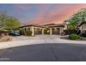 A beautiful single-story home with a circular driveway, desert landscaping, and a two-car garage at 2335 E Allen St, Phoenix, AZ 85042