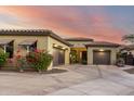 Single-story home featuring a circular driveway, two-car garage, desert landscaping, and a lovely exterior at 2335 E Allen St, Phoenix, AZ 85042