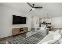 Open floor plan showcasing a stylish living room with modern features and kitchen with breakfast bar at 2511 W Queen Creek Rd # 266, Chandler, AZ 85248