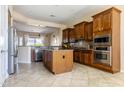 Open kitchen design with an island, stainless steel appliances, and ample cabinet space at 26168 W Tina Ln, Buckeye, AZ 85396