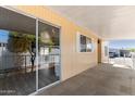 Inviting covered patio with sliding glass door access and neutral toned flooring at 2650 W Union Hills Dr # 131, Phoenix, AZ 85027