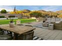 Inviting back yard features artificial turf, fire features, and ample seating with mountain views at 27203 N 78Th Ln, Peoria, AZ 85383