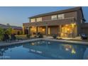 Gorgeous backyard pool with a covered patio featuring an outdoor kitchen and comfortable seating area at 27316 N Covered Wagon Rd, Phoenix, AZ 85085