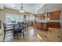 A gourmet kitchen with stainless steel appliances, center island, and an adjacent eat in kitchen nook at 27316 N Covered Wagon Rd, Phoenix, AZ 85085