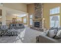 A spacious living room offers a stone fireplace and seamless flow to the dining area at 27316 N Covered Wagon Rd, Phoenix, AZ 85085