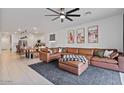 Spacious living room features a large sectional sofa and opens to the kitchen and dining area at 3187 E Pineapple Rd, San Tan Valley, AZ 85143