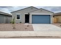 Charming single story home with a blue garage door and low maintenance desert landscaping at 3598 E Audrey Dr, San Tan Valley, AZ 85143