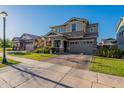 Inviting two-story home featuring a well-kept lawn, brick driveway, and a two-car garage at 3828 E Pinto Dr, Gilbert, AZ 85296