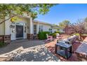 Inviting front entrance with a covered porch, brick accents, and comfortable seating area at 4030 N 54Th Pl, Phoenix, AZ 85018