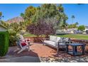 Relaxing outdoor patio featuring comfortable seating, a brick border, and views of the surrounding neighborhood at 4030 N 54Th Pl, Phoenix, AZ 85018