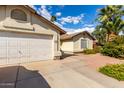 Charming home exterior featuring a well-kept yard, convenient driveway, and welcoming facade at 4102 W Fallen Leaf Ln, Glendale, AZ 85310