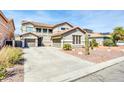 Beautiful two-story home featuring a three-car garage and desert landscaping for low maintenance at 44314 W Mescal St, Maricopa, AZ 85138