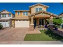 Charming two-story home featuring a covered porch, brick driveway, and two car garage at 5012 S Girard St, Gilbert, AZ 85298