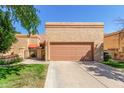 Charming single-story home with a well-maintained front yard and two-car garage at 563 N Spanish Springs Dr, Chandler, AZ 85226