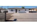 Charming house featuring a spacious driveway, mailbox, gravel landscaping, and a classic exterior paint scheme at 6130 N 27Th Ave, Phoenix, AZ 85017