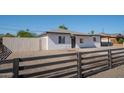 Charming home featuring a decorative dark wood fence, gravel landscaping, and a classic exterior paint scheme at 6130 N 27Th Ave, Phoenix, AZ 85017