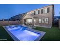 An inviting backyard featuring a pool with accent lighting and a covered patio for outdoor relaxation at 634 E Deer Creek Rd, Phoenix, AZ 85048