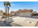 Attractive one-story home showcasing a tile roof, low-maintenance landscaping, and an attached two-car garage at 6341 S Cypress Point Dr, Chandler, AZ 85249