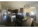 Modern kitchen featuring stainless steel appliances, granite countertops, and dark wood cabinetry at 650 N Hawes Rd # 3123, Mesa, AZ 85207