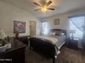 Cozy primary bedroom with a ceiling fan, dresser, nightstands, and plush carpeting at 650 N Hawes Rd # 3123, Mesa, AZ 85207